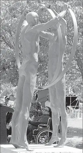  ?? Arkansas Democrat-Gazette/STATON BREIDENTHA­L ?? Little Rock Nine member Melba Pattillo Beals takes a look at United, a sculpture that was unveiled Friday afternoon at Little Rock Central High School.