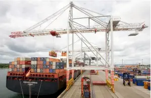  ??  ?? Cranes load containers onto a ship at Southampto­n port in the UK. Britain’s economy grew by a quarterly 0.6 per cent in the October-December period, helped by the services sector.