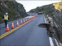  ?? NIC COURY — ASSOCIATED PRESS ?? Roger Morris, an assistant resident engineer with
MNS Engineers, assesses a break in the southbound lane of Highway 1at Rocky Creek Bridge in Big
Sur on Monday, following an
Easter weekend storm. Thousands of travelers were stranded overnight Saturday.