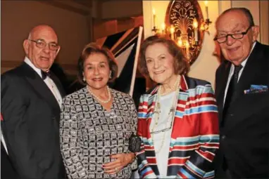  ??  ?? Dick and Lois Frieder of Elkins Park head off to look for their seats with Janet Kardon of New York City and Harvey Hewit of Philadelph­ia.