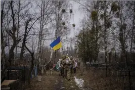  ?? EMILIO MORENATTI — THE ASSOCIATED PRESS ?? Ukrainian military officers carry a coffin during a funeral procession in Bucha, near Kyiv, Ukraine, on Friday. It holds Kasich Kostiantyn, 42, a senior lieutenant of the 93rd Ukrainian brigade who was killed on Tuesday in fighting in the Bakhmut area.