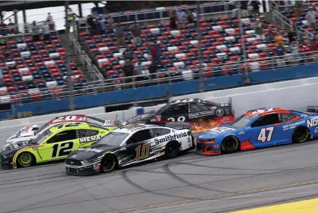  ?? Chris Graythen, Getty Images ?? Ryan Blaney, driver of the No. 12 Menards/Sylvania Ford, leads Erik Jones, driver of the No. 20 Sport Clips Toyota, and Aric Almirola, driver of the No. 10 Smithfield Ford, to win the GEICO 500 at Talladega Superspeed­way on Monday.