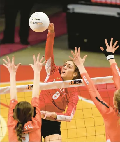  ?? ROB DICKER/DAILY SOUTHTOWN ?? Mother McAuley’s Ellie White (8) slams the ball over the net against St. Charles East during a Class 4A state semifinal match in 2022 at Illinois State’s Redbird Arena in Normal.