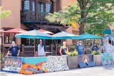  ?? COURTESY OF THE ROSEWOOD INN OF THE ANASAZI/DOUGLAS MERRIAM ?? From left, Joel Nakamura, Robb Rael, Shakti Kroopkin, John Paul Granillo, Jessica Ortiz and Lutz Arnhold in front of the Rosewood Inn of the Anasazi. The five artists painted the concrete barriers outside the restaurant.