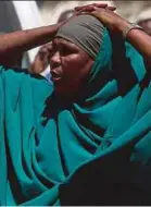  ?? PIC REUTERS ?? A woman reacting near the scene of a blast in the district office of Hawlwadag, Mogadishu, yesterday.