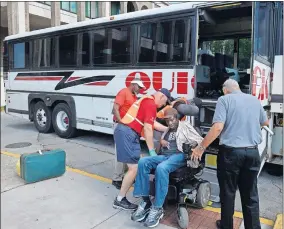  ?? BISSON/GATEHOUSE MEDIA] ?? Volunteers help a wheelchair bound man onto a charter bus at Savannah's Civic Center before getting a free ride to an inland shelter Tuesday afternoon in Savannah, Ga. [STEVE