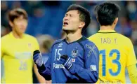  ?? — AFP ?? Gamba Osaka’s Yasuyuki Konno (centre) reacts next to Jiangsu Suning’s Tao Yuan during the AFC Champions League tie.