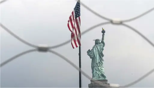  ?? DREW ANGERER GETTY IMAGES FILE PHOTO ?? The Statue of Liberty’s plaque with the casting of Emma Lazarus’s 1883 poem, “The New Colussus,” was added 10 years after the monument was completed.