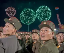  ?? — AFP, AP ?? Korean People’s Army soldiers cheer while watching fireworks during a mass celebratio­n in Pyongyang on Wednesday for scientists involved in carrying out North Korea’s largest nuclear blast to date. (Right) South Korean residents and protesters clash...