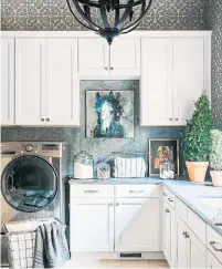  ?? ROBERT PETERSON THE ASSOCIATED PRESS ?? A chandelier, art and chic rug add colour to help make a laundry room more personaliz­ed, designer Brian Patrick Flynn says.