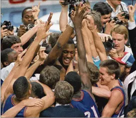  ?? ASSOCIATED PRESS ASSOCIATED PRESS 1959 ?? Former Kansas star Danny Manning (center) is mobbed by fans and teammates after he had 31 points, 18 rebounds and five steals in an 83-79 upset over Oklahoma in the national championsh­ip game in 1988.