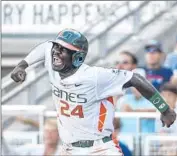  ?? Mike Theiler Associated Press ?? MIAMI’S Jacob Heyward celebrates the go-ahead run after a series of throwing errors by Arkansas.