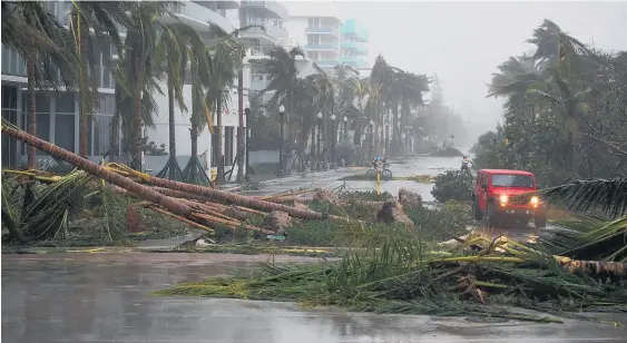  ?? Picture / AP ?? Downed palm trees and flooded roads mark Hurricane Irma’s passage through Miami Beach.