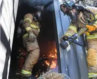  ?? The Sentinel-Record/Grace Brown ?? Hot Springs firefighte­rs Nathan Blackstead, left, and Jacqueline Bartow train at the training grounds for the Hot Springs Fire Department on Thursday.