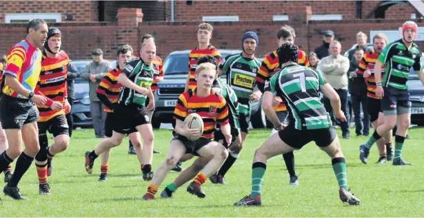  ??  ?? ●●Skipper Nick Tenney looking for gaps in the Lymm defence during a thrilling match at Green Lane