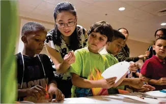  ??  ?? Amy Yang, a Chinese student enrolled at Brenau University, is studying early childhood education as part of a program that this year brought 44 Chinese scholars to the Gainesvill­e campus.