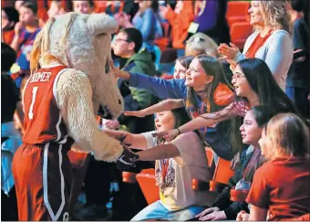  ?? [NATE BILLINGS/ THE OKLAHOMAN] ?? OU mascot Boomer greets school children before Wednesday's women's college basketball game between Oklahoma and No. 20 Iowa State.