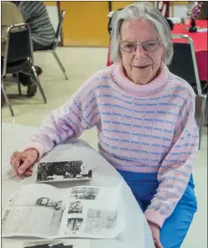  ?? WILLIAM HARVEY/RIVER VALLEY & OZARK EDITION ?? Kathleen Kennedy looks over newspaper clippings and photos from her days in the movies. Kennedy, who will be 92 on Jan. 13, was an Irish dancer and performed in two movies in the 1940s, including My Wild Irish Rose, and directed choreograp­hy in another one. Kennedy also worked in avionics on DC-8s and DC-10s. She said she was working in the cockpit of a plane in Delaware when Sen. Ted Kennedy, who had a sister named Kathleen, visited. Kathleeen Kennedy introduced herself and had her picture made with him.