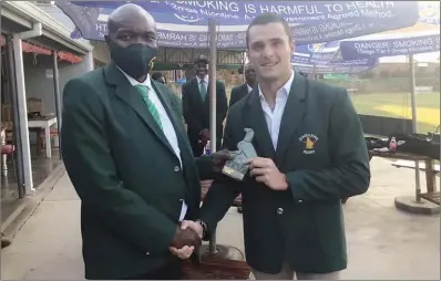  ??  ?? ZRU president Aaron Jani (left) presents the man of the match award to Sables scrumhalf Dudlee White-Sharpley after the second match against Burkina Faso at Old Georgians Sports Club in Harare last week