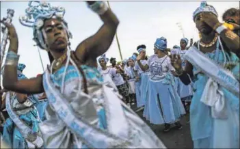  ??  ?? Feeling it: Revellers dance during the Afoxe Ile Ala ‘bloco’, in Rio de Janeiro. The ‘bloco’ celebrates the Afro-brazilian Candomblé religion. Photo: Mario Tama/getty Images