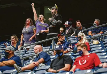  ?? Jon Shapley / Staff photograph­er ?? Minnesota Vikings fans holler after a touchdown late in the team’s 31-23 win over the Texans at NRG Stadium on Sunday.