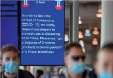  ??  ?? SAfE DiStAncE PlEASE: An informatio­n board alerts passengers to maintain a safe distance at Dubai internatio­nal Airport on Monday. —