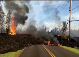  ?? ASSOCIATED PRESS ?? IN THIS SATURDAY, PHOTO PROVIDED BY THE U.S. GEOLOGICAL SURVEY, lava from Fissure 7 slowly advances to the northeast on Hookapu Street in the Leilani Estates subdivisio­n in Pahoa, Hawaii. The Kilauea volcano sent more lava into Hawaii communitie­s...