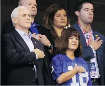  ?? MICHAEL CONROY/THE ASSOCIATED PRESS ?? Vice-President Mike Pence and his wife Karen stand during the playing of the U.S. national anthem before Sunday’s NFL game in Indianapol­is. Pence left over an anthem protest.