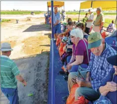  ?? PHOTO VINCENT OSUNA ?? Guests wait on a hay wagon as the tour prepares to make its next stop during Farm Smart’s Veggie Express Farm Tour on Friday in Holtville.