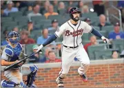  ?? Photos by John Bazemore, The Associated Press ?? LEFT: Atlanta’s Nick Markakis follows through on a double during the sixth inning.