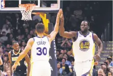  ?? Jack Dempsey / Associated Press ?? The Warriors’ Stephen Curry celebrates with Draymond Green after burying a three-pointer against the Nuggets.