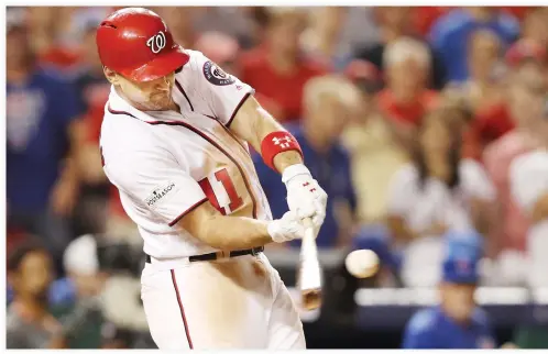  ??  ?? Ryan Zimmerman of the Washington Nationals hits a three run home run against the Chicago Cubs in the eighth inning during Game 2 of the National League Division Series at Nationals Park on Saturday in Washington, DC. (AFP)