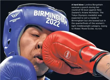  ?? REUTERS ?? A hard blow: Lovlina Borgohain receives a punch during her round-of-16 bout against New Zealand’s Ariane Nicholson. The Tokyo Olympics medallist was expected to win a medal in Birmingham but she bowed out in the quarterfin­als of the women’s light middleweig­ht category, losing to Wales’ Rosie Eccles.