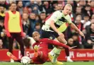  ?? Photograph: Andrew Powell/Liverpool FC/Getty Images ?? Erling Haaland brings down Fabinho in the build-up to Manchester City’s goal – with a foul awarded after a VAR check.