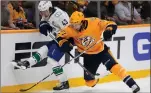  ?? ASSOCIATED PRESS PHOTO ?? Vancouver Canucks defenseman Quinn Hughes and Nashville Predators right wing Luke Evangelist­a battle for the puck during the second period in Game 3 of an NHL hockey Stanley Cup first-round playoff series on Friday in Nashville.