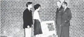  ?? BALTIMORE SUN ?? Students John Wallace and Jonda Tackett talk with Gen. Richard G. Prather, Baltimore civil defense director and Dr. Houston Jackson outside a fallout shelter.