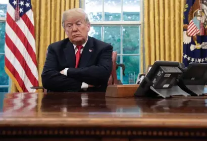  ?? GETTy IMAgEs fILE ?? NAME BLAME: Then-President Donald Trump sits in the Oval office in October 2018. Trump is trying to prevent the Republican National Committee from using his name in fundraisin­g. Trump says he has no problem with the RNC, but he does with ‘RINOs and fools.’