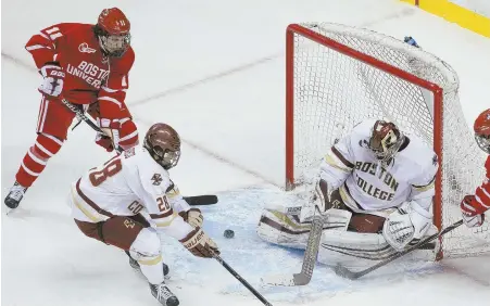  ?? STAFF PHOTOS BY NICOLAUS CZARNECKI ?? THE SWEETEST ‘W’: Above, Patrick Curry puts the game-winner past BC’s Joe Woll at 15:40 of overtime last night at the Garden, advancing BU into tonight’s Hockey East final and likely ending rival BC’s season.