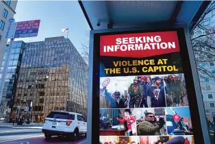  ?? ERIN SCOTT/NEW YORK TIMES ?? An FBI notice is posted seeking informatio­n about the pro-Trump mob that invaded the Capitol on Jan. 6 at a bus stop near the White House in Washington. Much is still unknown about the planning and financing of the storming of the Capitol, aiming to challenge Trump’s electoral defeat. What is clear is that it was driven, in part, by a largely ad hoc network of low-budget agitators.