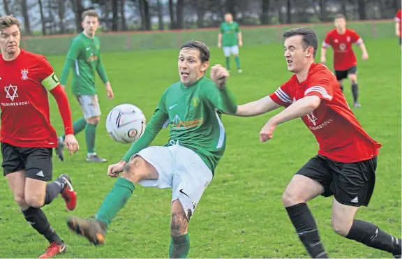  ?? Picture: Peter Rundo. ?? Action from the East Region League Cup clash between Tayport (red strips) and Lochee Harp at The Cainniepai­rt.