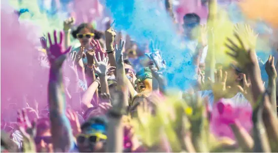  ?? Picture: EPA ?? Participan­ts throw coloured powder into the air prior to the start of the Unicaja Colour Road charity run in Malaga, southern Spain. The funds raised will go to the UN Children’s Fund Unicef.