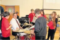  ??  ?? Steve Jones, leading percussion tutor with students