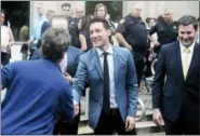  ?? JAMES NIELSEN — HOUSTON CHRONICLE VIA AP ?? David Daleiden, center, speaks with supporters Tuesday outside the Harris County Criminal Justice Center in Houston.