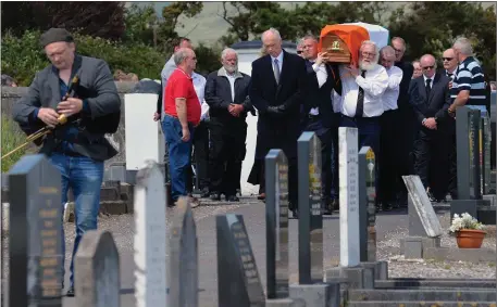  ?? The Tri-colour draped coffing of Seán Mairtín Bácéir being shouldered into Milltown cemetery on Friday. Photo by Declan Malone ??