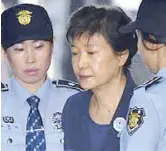  ??  ?? Former South Korean president Park Geun-hye is escorted by security officers in Seoul last year.