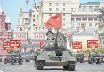  ??  ?? A Soviet T-34 tank parades through Red Square during the Victory Day military parade. — AFP photo