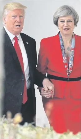  ??  ?? Hands on... Mrs May with Mr Trump at the White House in January