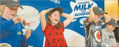  ??  ?? Happy times: Maria Kelly laughs as she wins the fastest folder competitio­n to celebrate a year of Milk for Schools.