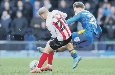  ?? ?? Sunderland’s Alex Pritchard is fouled by Wimbledon’s Luke McCormick – who was later send off for two yellow cards. Picture: Frank Reid