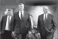  ?? AP/JACQUELYN MARTIN ?? Kevin Downing (center) and Thomas Zehnle (right), the defense team for Paul Manafort, arrive Wednesday at federal court in Alexandria, Va., for the continuati­on of Manafort’s trial.